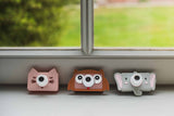 odalmix of elephant, owl and cat kids digital cameras, standing next to each other on window sell