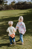odalsilicon bag fox and unicorn, kids are carrying the bags around their neck while walking hand in hand in the garden