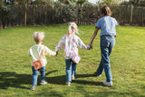 odalsilicon bag fox and unicorn, kids are carrying the bags around their necks while walking in the garden, hand in hand