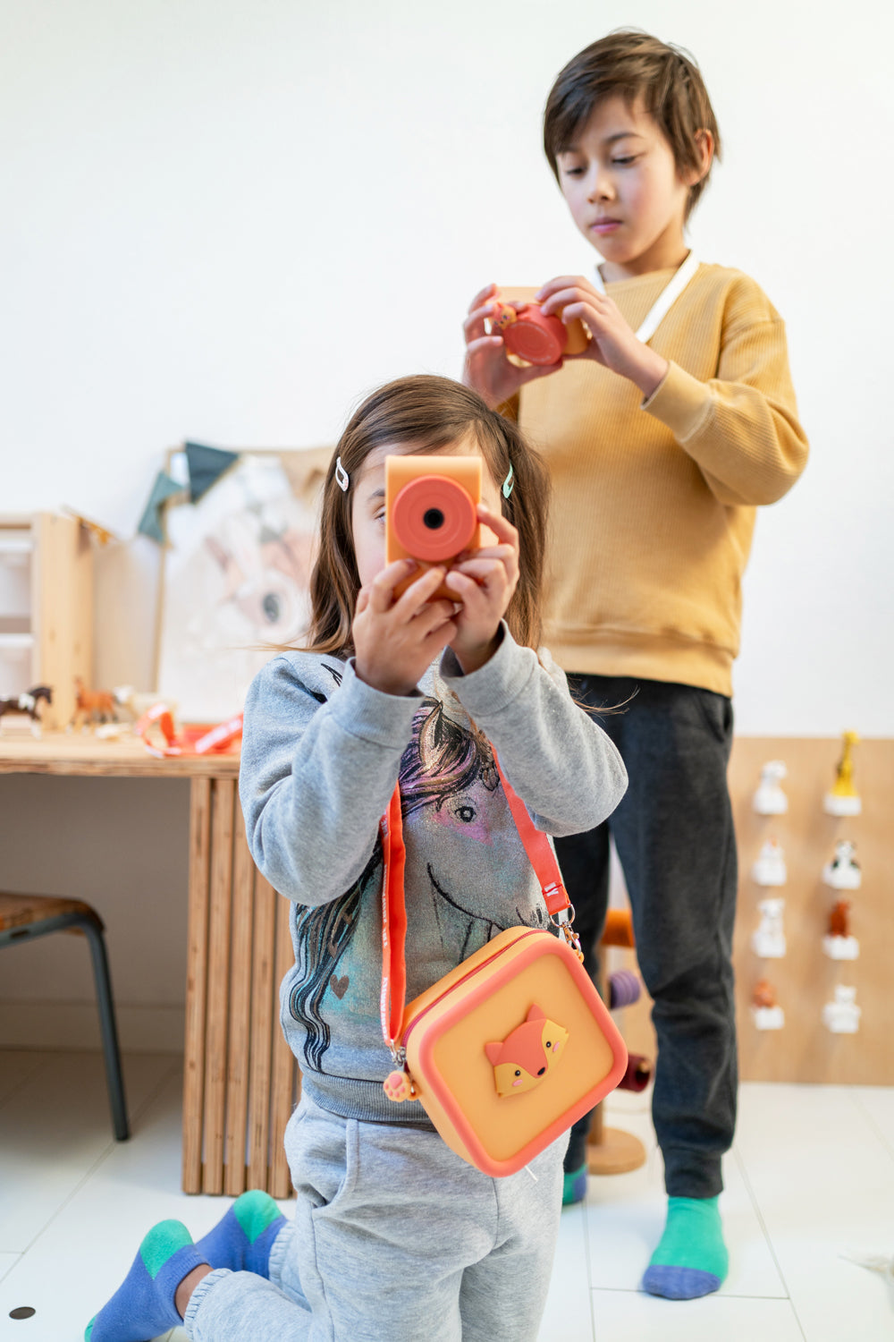 silicon bag fox and urban zoo fox digital kids camera, children are playing with the cameras at kidsroom, bag around childs neck