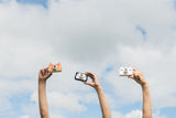 odalfjox, penguin and unicorn kids cameras, children holding them in the air