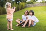 odalunicorn kids camera, little child makes picture of friends sitting in garden