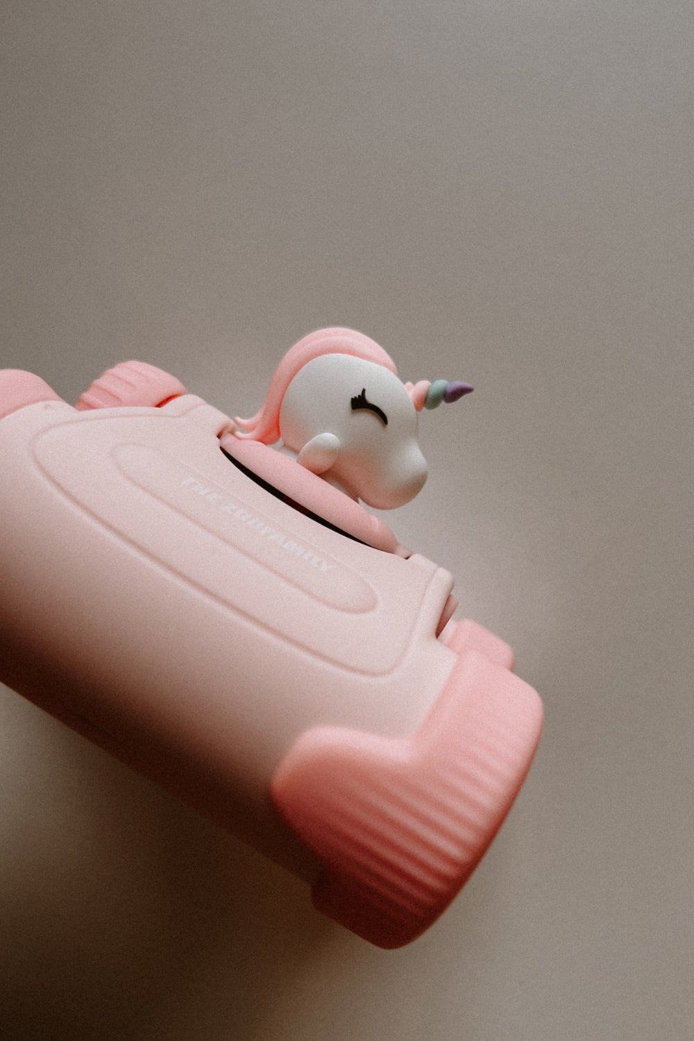 The binoculars are lying on their side on the surface.